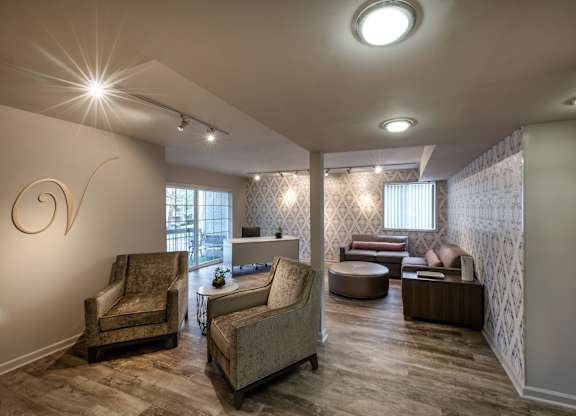A living room with a grey sofa and a wooden coffee table.