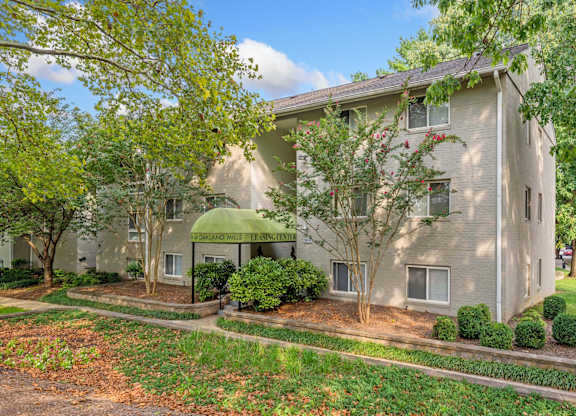 A building with a green awning and a sign that says "Congdon Woods Apartments".