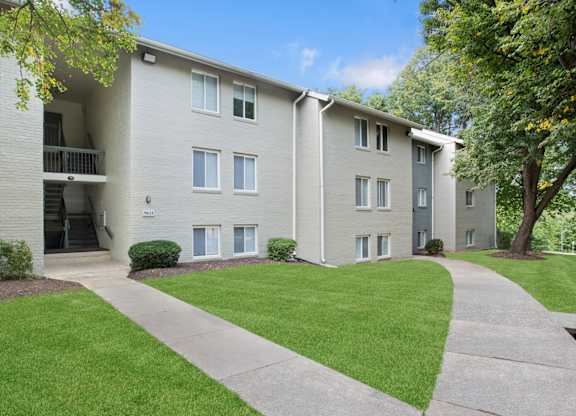 Apartment building with a green lawn in front.