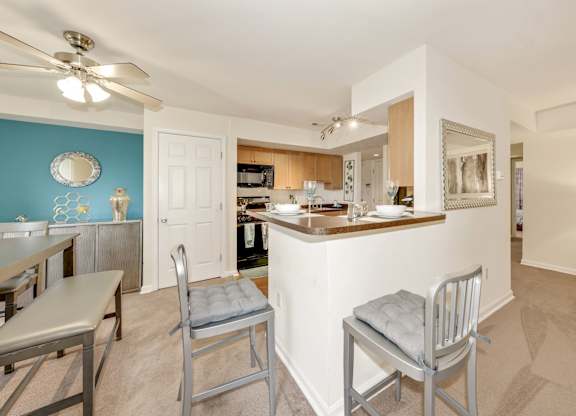 A kitchen with a blue wall and a white counter.