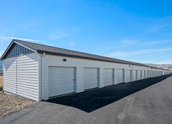 A long row of white garage doors are closed.