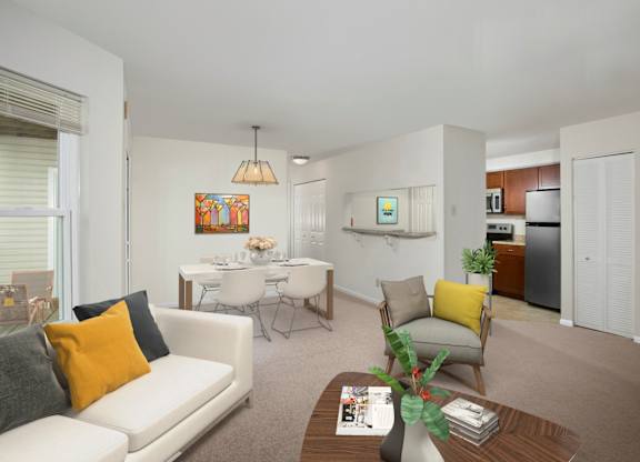 A living room with a white couch, a coffee table, and a dining table.