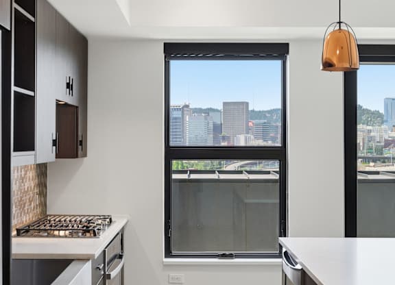 A modern kitchen with a view of the city.