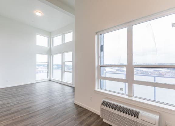 Harbor Sky Living Room with Large Windows and Private Balcony