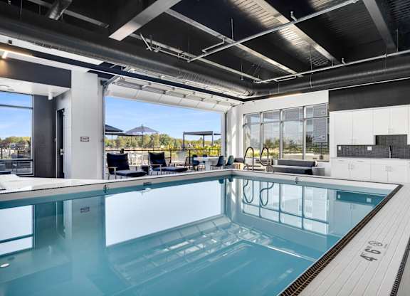 A large indoor swimming pool with a glass bottom.
