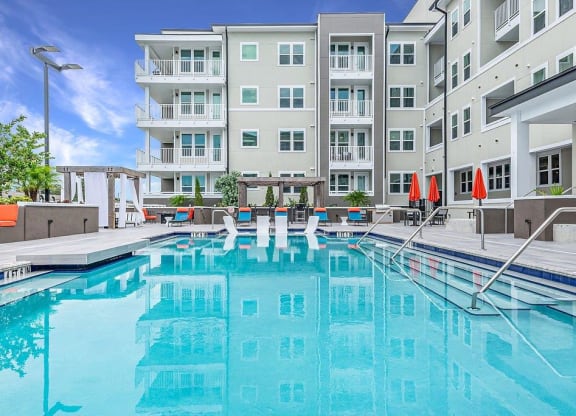 a swimming pool with a building in the background
