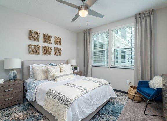 a bedroom with a bed and a ceiling fan