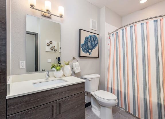 a bathroom with a toilet sink and shower