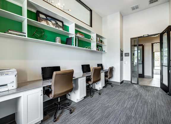 A room with a white desk and a printer on it.