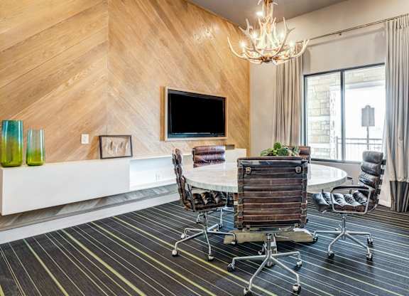 A modern living room with a wooden wall and a flat screen TV.