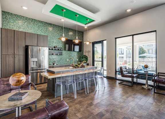 A modern kitchen with a bar area and a view of the city.