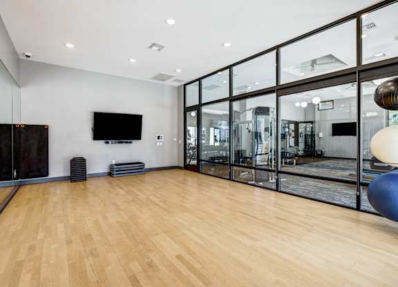 A room with a wooden floor and a glass wall.