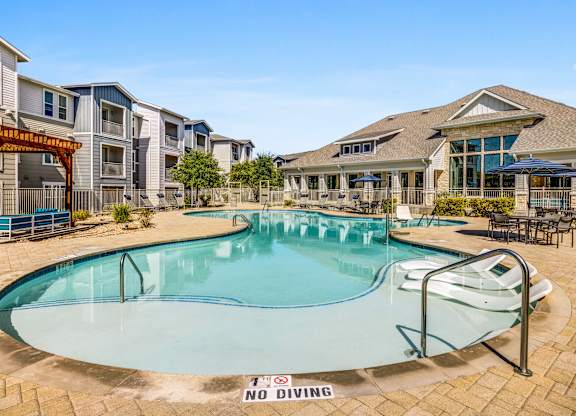 A pool with a no diving sign in the middle.