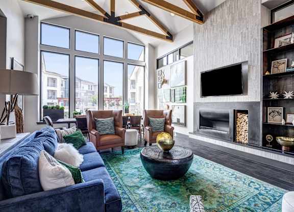 A living room with a blue couch and a television.