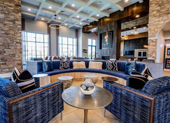 A living room with a stone pillar and a blue couch.