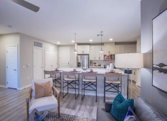 A modern kitchen with a dining table and chairs.