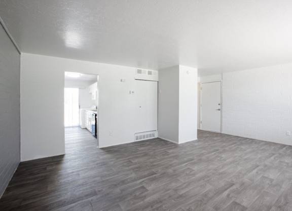 A room with a wooden floor and white walls.