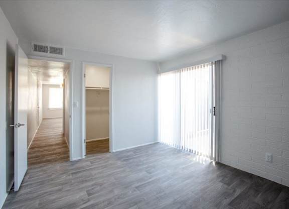 A room with white walls and a wooden floor.