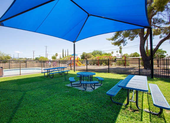 A blue canopy is over a picnic table.
