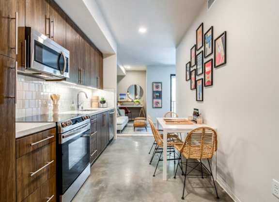 A modern kitchen with a dining table and chairs.