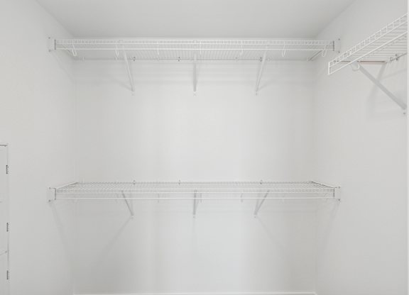 Empty white shelves in a room.