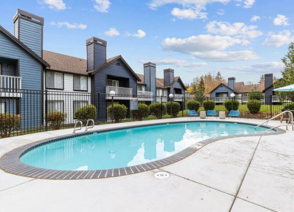 a swimming pool with apartments in the background