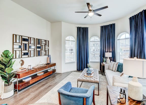 The Dylan living room with white walls and blue curtains