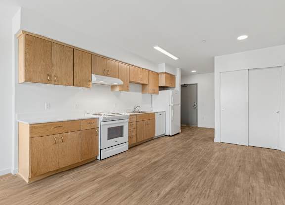A kitchen with wooden cabinets and white appliances.