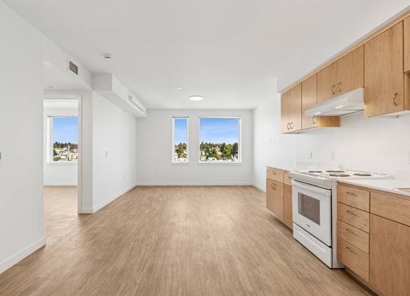 A kitchen with wooden floors and white walls.