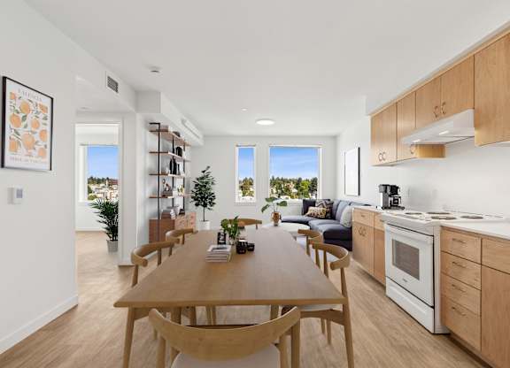 A modern kitchen with a dining table and chairs.