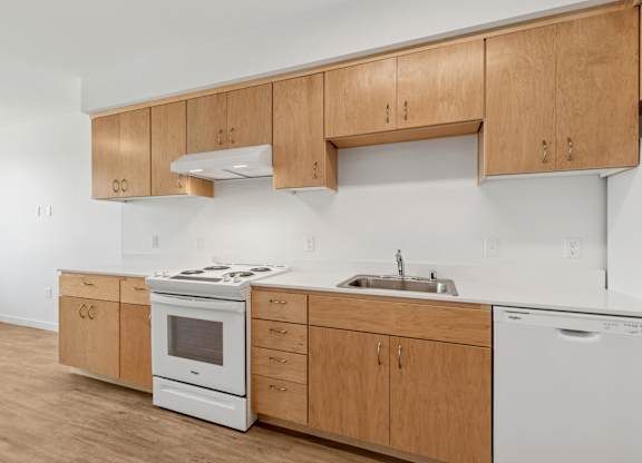 A kitchen with wooden cabinets and white appliances.