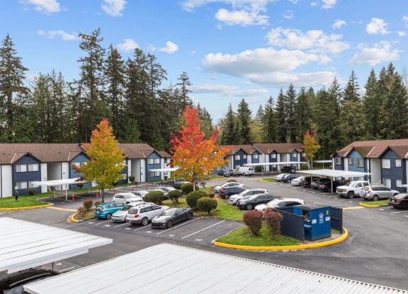 a parking lot filled with cars in front of houses