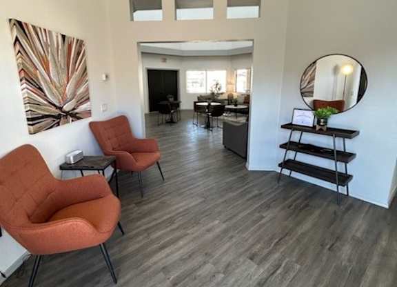 A living room with a grey floor and white walls.