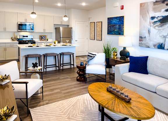 A modern living room with a wooden coffee table and a white couch.
