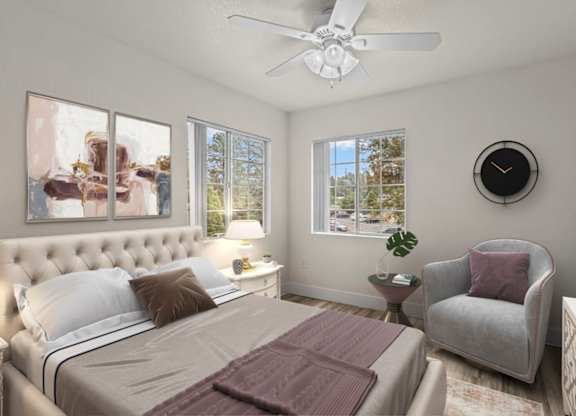 A bedroom with a large bed, a chair, and a ceiling fan.