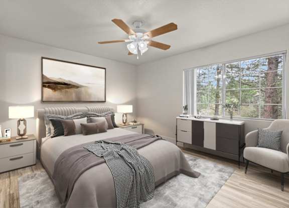 A bedroom with a large bed and a ceiling fan.