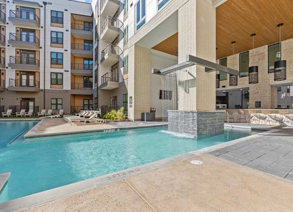 A swimming pool in front of a modern building.