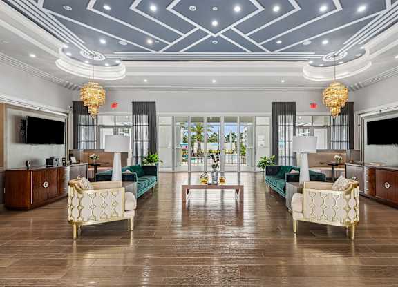 A spacious living room with a green sofa and a wooden floor.