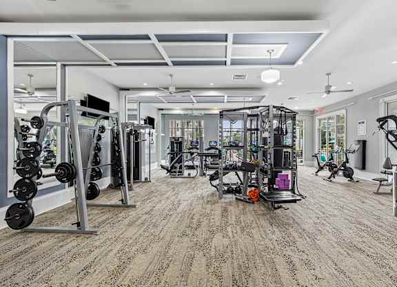 A spacious gym with a variety of equipment.