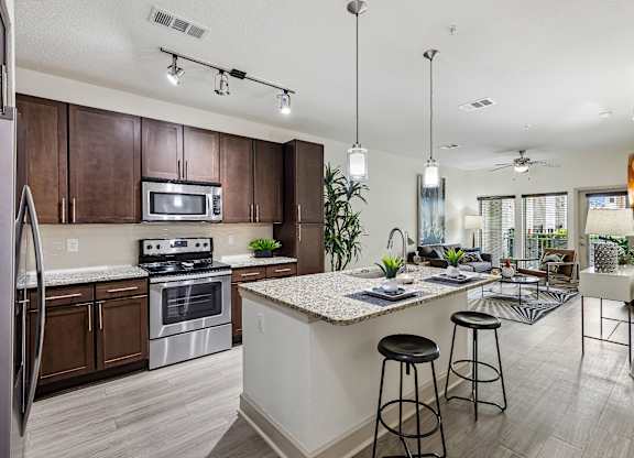 A kitchen with a white counter top and a refrigerator.