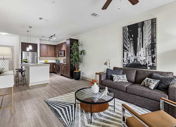 A living room with a grey couch and a coffee table.