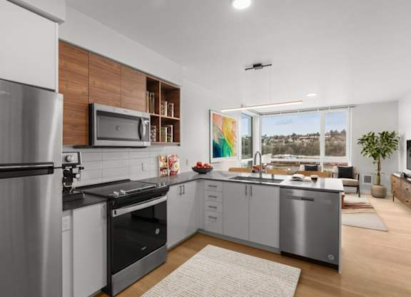 A modern kitchen with a stainless steel refrigerator and microwave.
