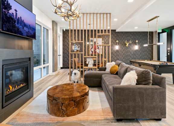 A modern living room with a fireplace and a large TV.