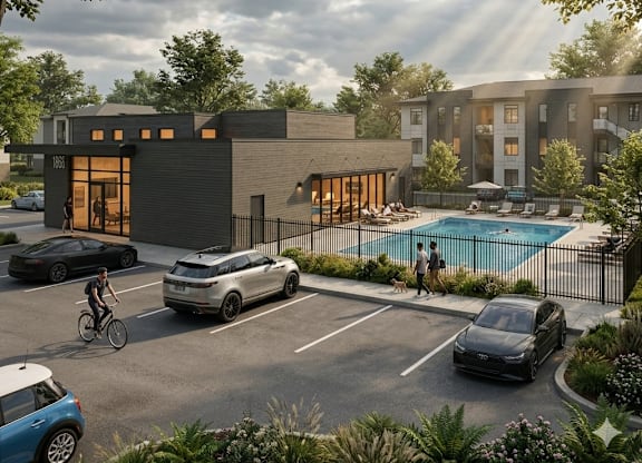 A modern building with a pool and cars parked in front.