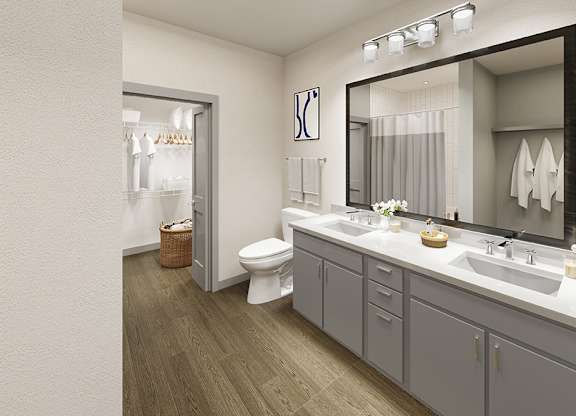 A bathroom with a toilet, sink, and mirror.