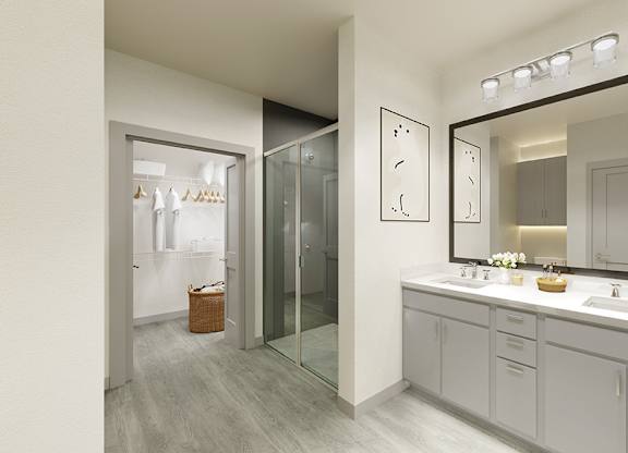 A bathroom with a mirror, sink, and a glass door.