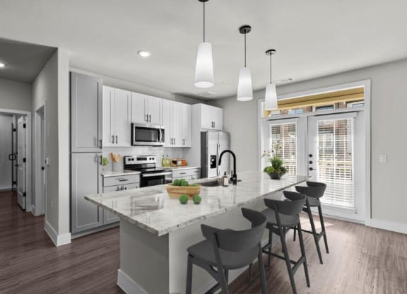 an open kitchen with a marble counter top at Lenox Grand, Austin Texas
