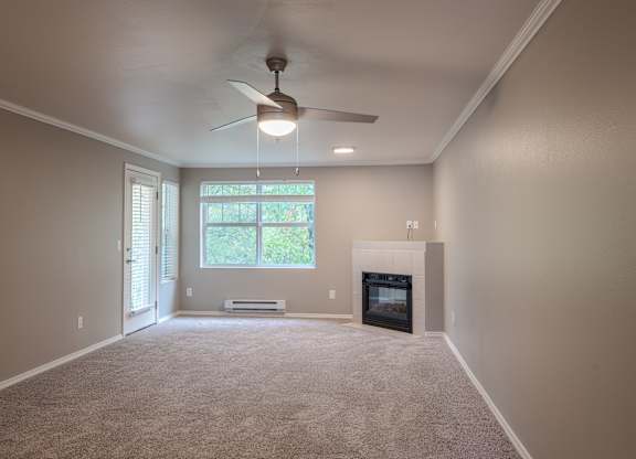 A room with a fireplace and a ceiling fan.