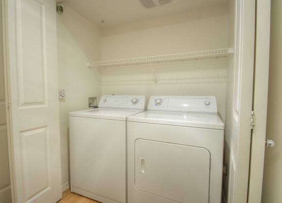 A small laundry room with a washer and dryer.