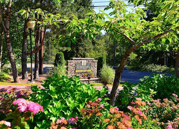 A garden with a sign that says Lamanai in the background.